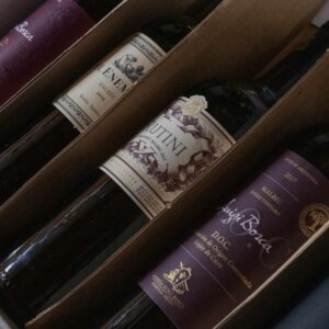 A selection of fine Argentinian wines in a box featuring various labels and vintages, perfect for wine enthusiasts.